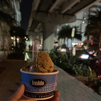 Freddo - a hand holding a cup of ice cream - Desserts Near Me - Miami, Florida