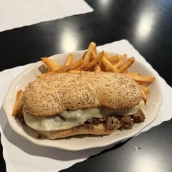 Moe Joe's Family Restaurant - Cheese steak sandwich on a seeded role and French fries