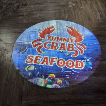Yummy Crab - Yummy Crab logo projected onto the floor - Seafood Near Me - Omaha, Nebraska