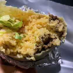 Las Cocinas Mexicanas - The sliver of chewy carne Asada Burrito/Steak Burrito in the sea of rice.
