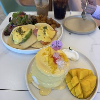 Gram Cafe & Pancakes - Mango soufflé pancake Egg Benedict Pancakes  Instagram: @hungrytamale - Pancakes Near Me - Irvine, California