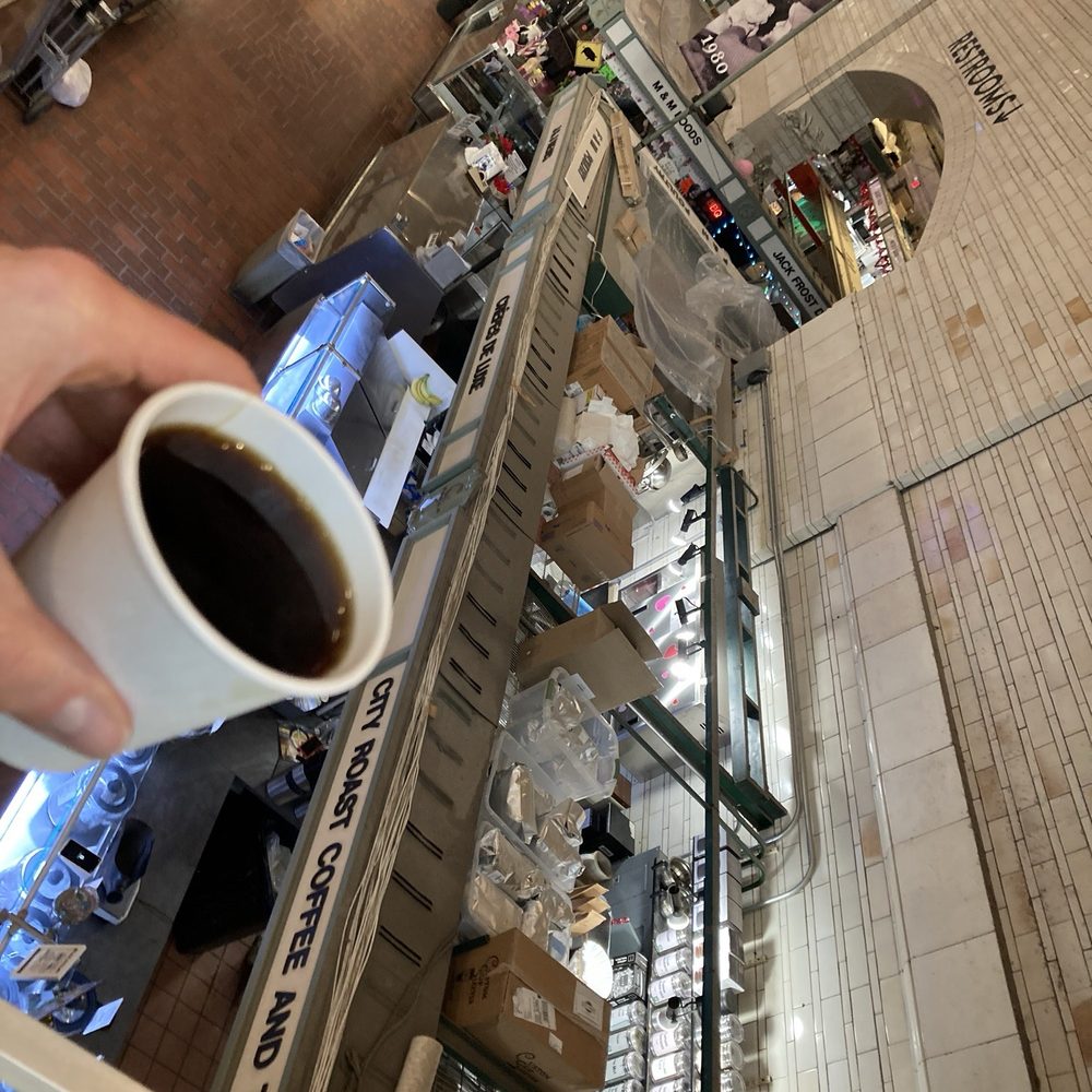 City Roast Coffee and Tea - a person holding a cup of coffee - Coffee & Tea Near Me - Cleveland, Ohio