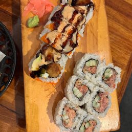 a variety of sushi on a wooden board