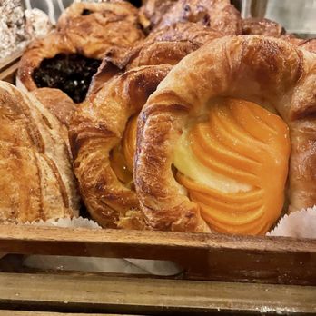 Monkey Cup - Tray of side stacked danishes multiple peach danishes and blueberry danishes can be seen. - Coffee & Tea Near Me - New York, New York