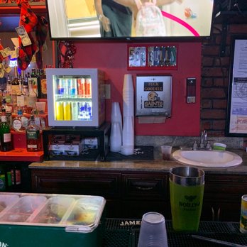 Red Door - a woman in a green shirt on a television screen - Lounges Near Me - New Orleans, Louisiana Red Door - a woman in a green shirt on a television screen - Lounges Near Me - New Orleans, Louisiana