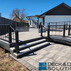 Deck and Drive Solutions - Stone deck with ramps, custom water feature. and upgraded cable railing.