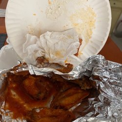 Brooklyn Pizzeria - 4 of 5 overly cooked and tough buffalo wings and 1/2 of a slice of pepperoni pizza that wasn't worth eating .