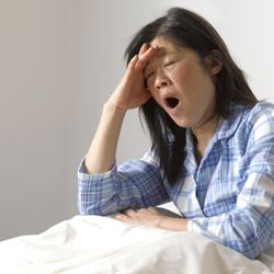 The Insomnia and Sleep Institute of Arizona - Woman yawning in Bed