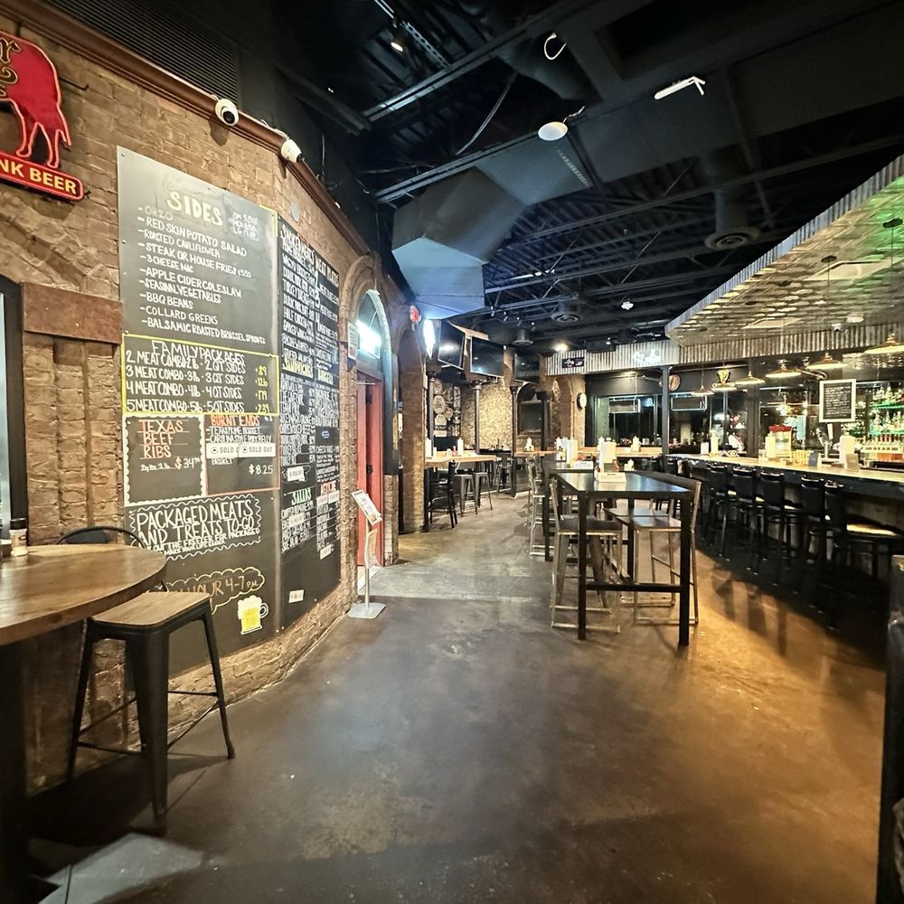 OAK'D BBQ - bar area to the right with the order line through the door by the menu on the left - Barbeque Near Me - Addison, Texas