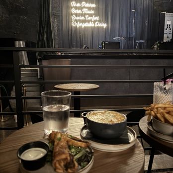 The Prewitt - The main stage with the string lights and neon sign - Steakhouses Near Me - Plainfield, Indiana