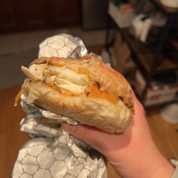 Lincoln Station - a hand holding a half eaten sandwich - Coffee & Tea Near Me - Brooklyn, New York