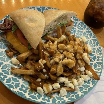 The Village Idiot - How to lose a chick in ten bites garlic pesto chicken club with poutine - American Near Me - Revelstoke, British Columbia The Village Idiot - How to lose a chick in ten bites garlic pesto chicken club with poutine - American Near Me - Revelstoke, British Columbia