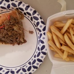 Half of a small cheesesteak with fries Half of a small cheesesteak with fries