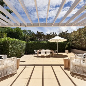 Greenpro Direct - Oxnard - a pergolated patio with white furniture - Landscaping Near Me - Oxnard, California Greenpro Direct - Oxnard - a pergolated patio with white furniture - Landscaping Near Me - Oxnard, California