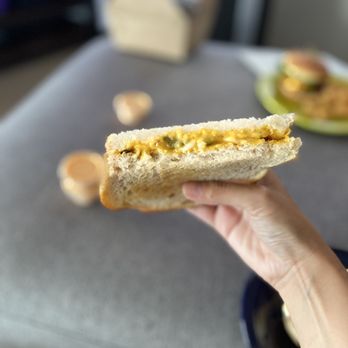 Bayside Cafe - a hand holding a half eaten sandwich - Coffee & Tea Near Me - Everett, Washington Bayside Cafe - a hand holding a half eaten sandwich - Coffee & Tea Near Me - Everett, Washington