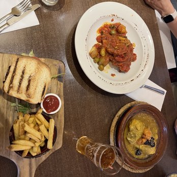 Meimo - Melting Goat Cheese and Onion Burger, Poulet à la Tomate (white plate), and Chicken Tagine with Apricots and Prunes - Mediterranean Near Me - Windsor, WNM