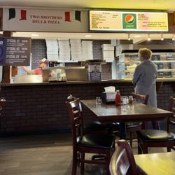 Two Brothers Deli & Pizza - Counter and menu