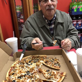 Papa G's Pizza Express - a man eating a pizza - Pizza Near Me - Miami, Oklahoma