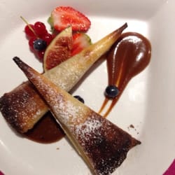Dessert of crepes with apples and caramel.