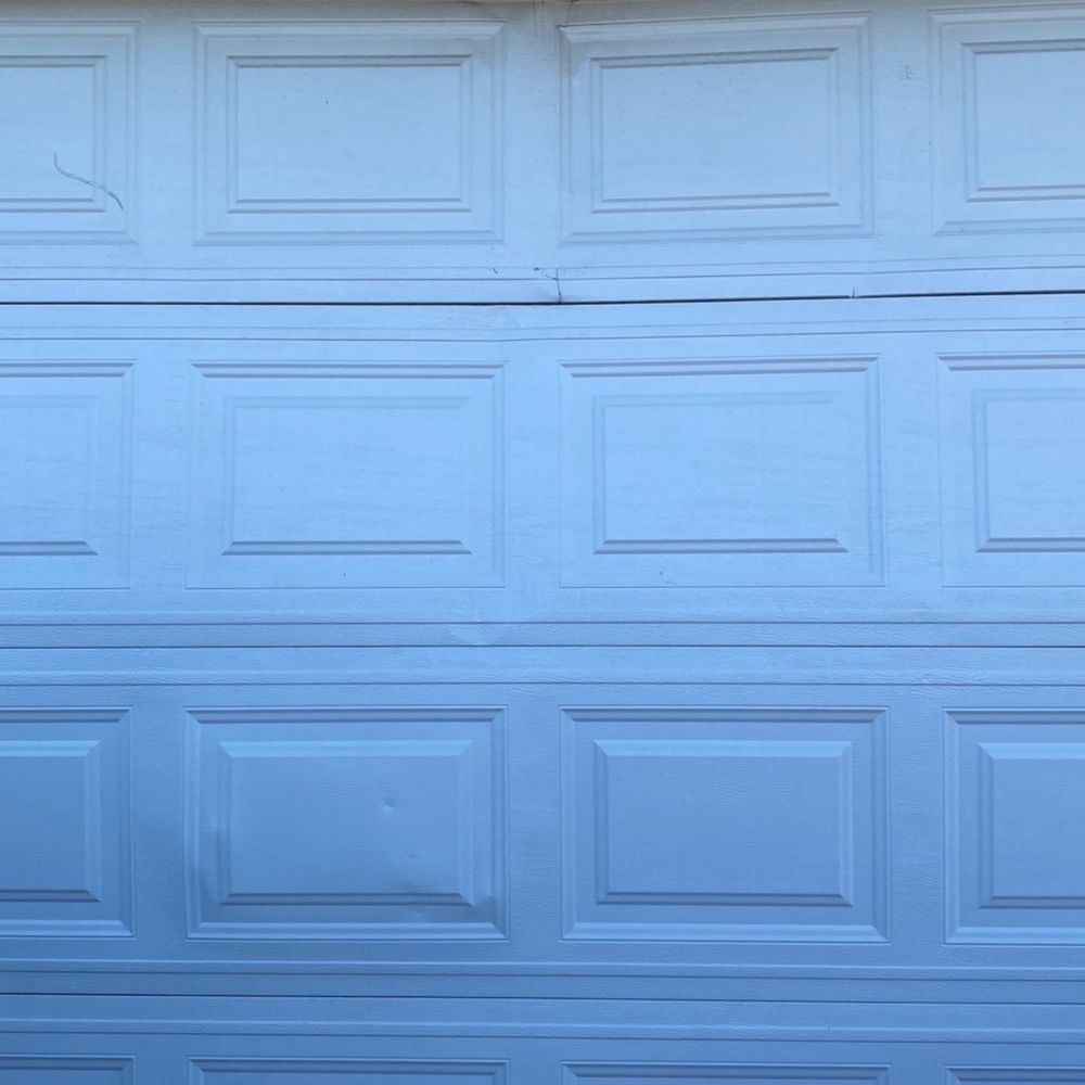 MOJA Garage Doors - Broken garage door. You can see the damages on the panels. - Garage Door Services Near Me MOJA Garage Doors - Broken garage door. You can see the damages on the panels. - Garage Door Services Near Me