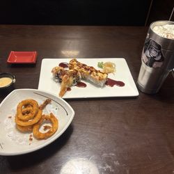 Sakura Grill - Calamari (half eaten), sushi, bottle of eel sauce on the left, my own drink on the right