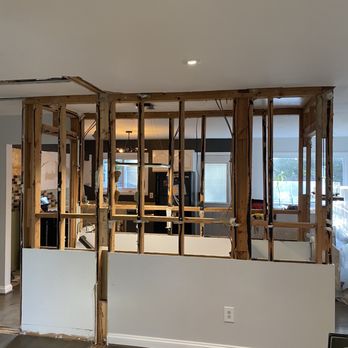 JAKE Premium Renovations - Wall which was halfway removed. This is also the basement staircase - General Contractors Near Me