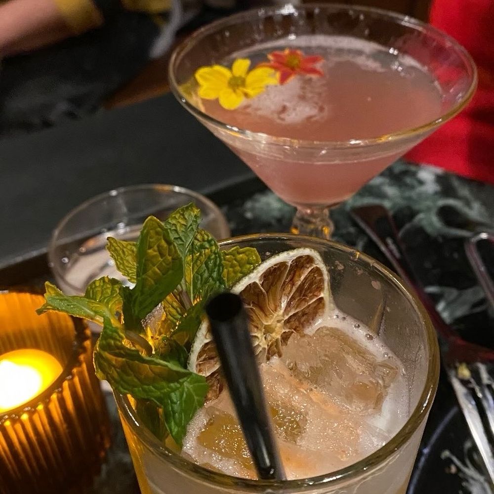 The Botanist - Pineapple Express (front) and a seasonal February drink, Twin Flames. - Cocktail Bars Near Me - Bakersfield, California The Botanist - Pineapple Express (front) and a seasonal February drink, Twin Flames. - Cocktail Bars Near Me - Bakersfield, California
