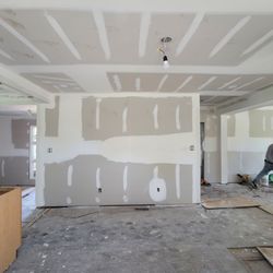 Custom Homes - Drywall Installation after demo of the chimney/cabinet walls to create an open floor plan concept with a kitchen bar
