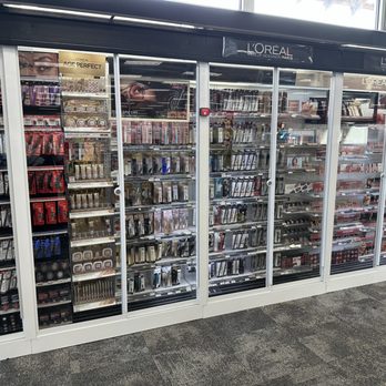 CVS Pharmacy - a view of an aisle with a variety of products - The image shows a large glass display case filled with various makeup products such as lipsticks, eyeshadows, brushes, and other cosmetics. The display is located inside CVS Pharmacy in Espanola, NM, with the products organized on multiple shelves behind glass doors. The store's branding, L'Oréal, is visible on the top of the display case. - Drugstores Near Me - Espanola, New Mexico