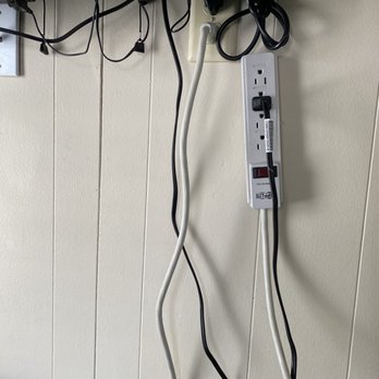 Island Time Inn - All of this electrical junk hung from each tv. Thank goodness we didn't have small children. - Vacation Rentals Near Me - Bradenton Beach, Florida