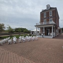 Action Events - Tent and white resin padded chairs for wedding