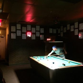 Tallyho Cocktail Lounge - a man playing pool - Dive Bars Near Me - Scottsdale, Arizona