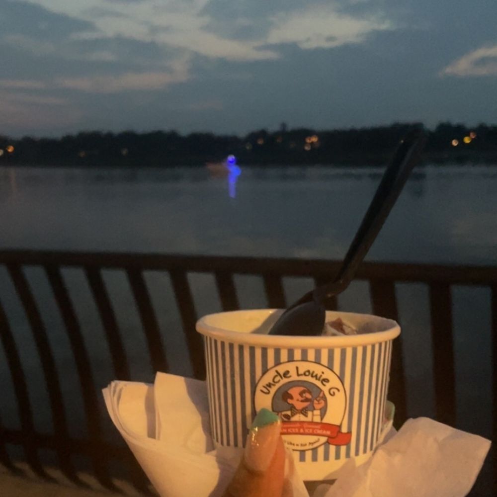 a person holding a cup of ice cream a person holding a cup of ice cream