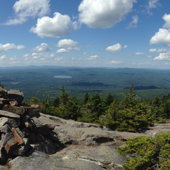 Mount Kearsarge - "Carrins" are rock piles that help mark the way for hikers as a sign points out on the mountain - Parks Near Me - Warner, New Hampshire