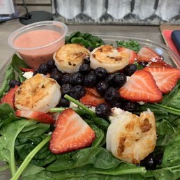 a salad with scallops, strawberries, and blueberries a salad with scallops, strawberries, and blueberries