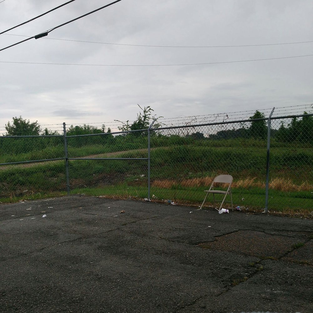 Cell Phone Lot - This chair been in this corner of the lot for a long time! - Parking Near Me - Kenner, Louisiana Cell Phone Lot - This chair been in this corner of the lot for a long time! - Parking Near Me - Kenner, Louisiana