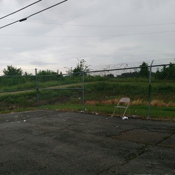 Cell Phone Lot - This chair been in this corner of the lot for a long time! - Parking Near Me - Kenner, Louisiana