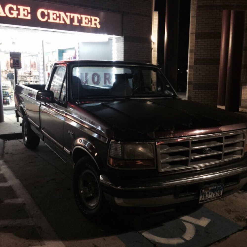 a truck parked in front of a store