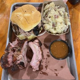 Brisket sandwich, baby back ribs, and German potato salad. Brisket sandwich, baby back ribs, and German potato salad.