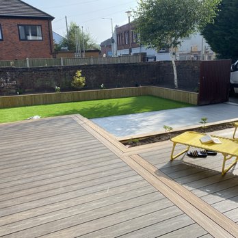 Abel Landscaping - Garden makeover composite deck porcelain driveway in rear garden artificial grass and raised beds - General Contractors Near Me - Liverpool, XMS