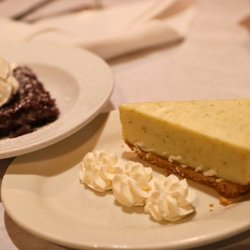 JK's Restaurant - A smooth, tangy slice of key lime cheesecake rests on a buttery graham cracker crust and is served with delicate swirls of wh...