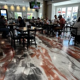 people sitting at tables in a restaurant people sitting at tables in a restaurant