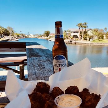 Hernando Beach Tropical Grille - Those freaking amazing conch  fritters and the view - American Near Me - Hernando Beach, Florida