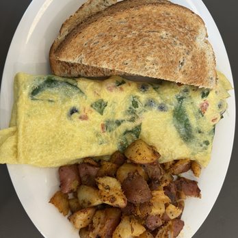 Eggs Up Grill - Greek Omelet with home fries and rye toast - Breakfast & Brunch Near Me - Orlando, Florida Eggs Up Grill - Greek Omelet with home fries and rye toast - Breakfast & Brunch Near Me - Orlando, Florida