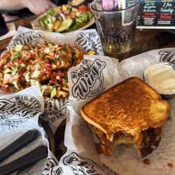 Bbq burger with Texas toast and loaded waffle fries with chicken avocado and a bbq sour cream