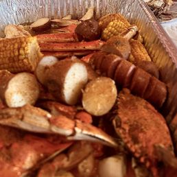 Family boil customized with crab legs, scallops, blue crab, potatoes, corn, and sausage, seasoned with butter and old bay.