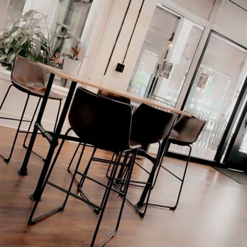Indah Coffee - a table and chairs in a coffee shop - Coffee Roasteries Near Me - Columbia, South Carolina