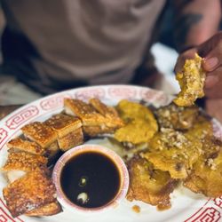 Zhencha - My husband absolutely devoured this plate of perfectly fried Pork Belly (crispy and tender) and them garlic tostones!!