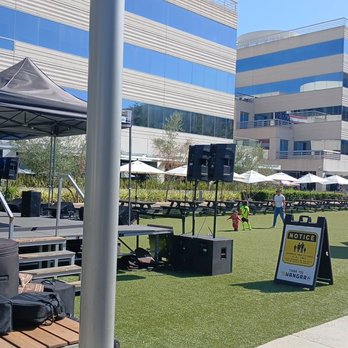 Hangar 24 Craft Brewing - A view of the area where the bands perform and the children run and play and it's just such a great atmosphere full family atmosphere. - Venues & Event Spaces Near Me - Irvine, California