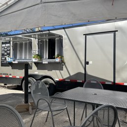 a food truck parked in a parking lot a food truck parked in a parking lot